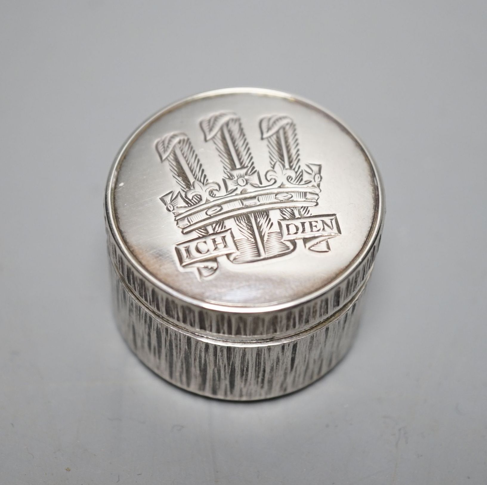 Adrian Gerald Benney- A modern textured silver pill box, engraved with the Prince of Wales feathers, London, 1997